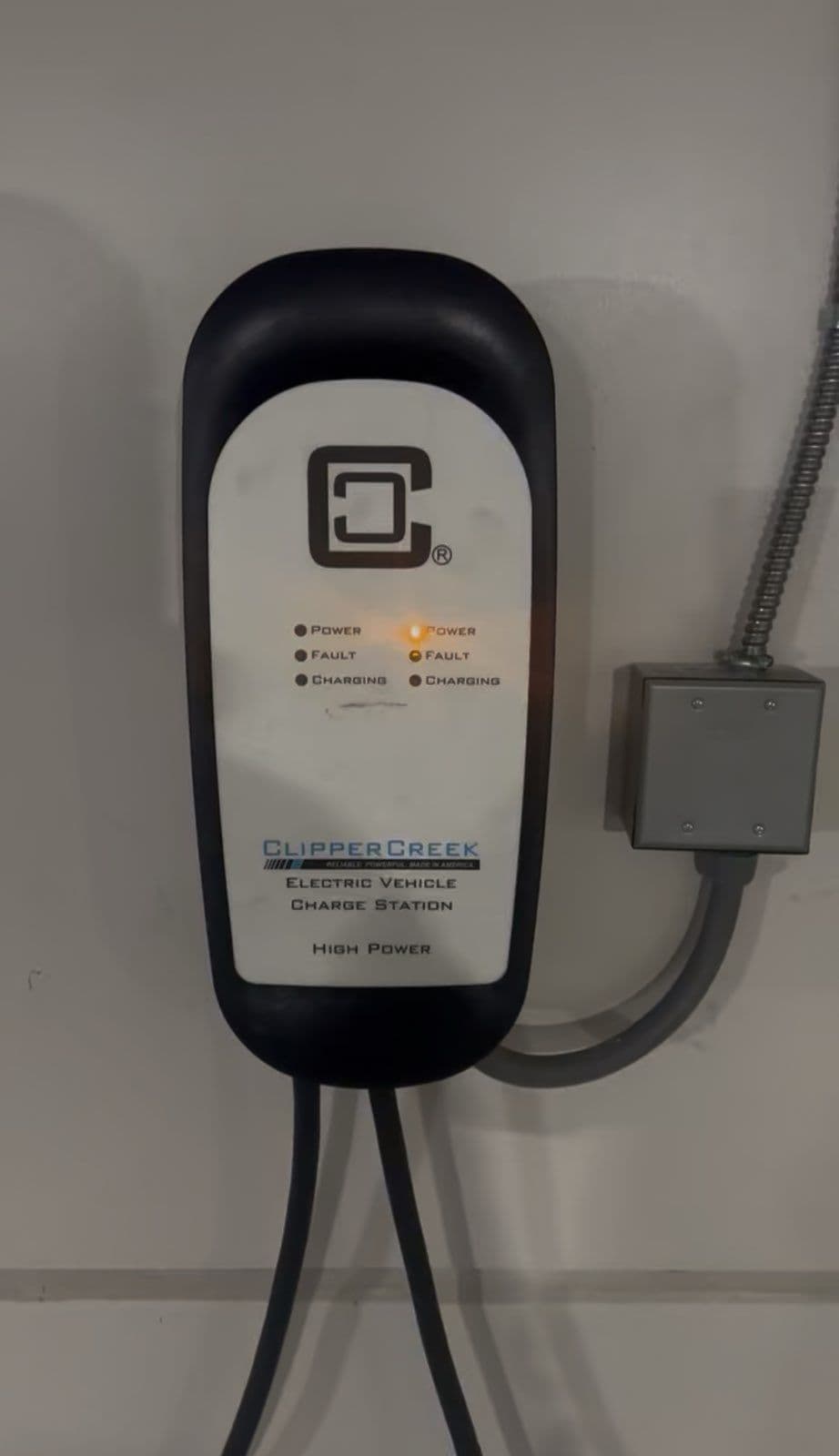 ClipperCreek electric vehicle charging station with indicators for power and fault status.